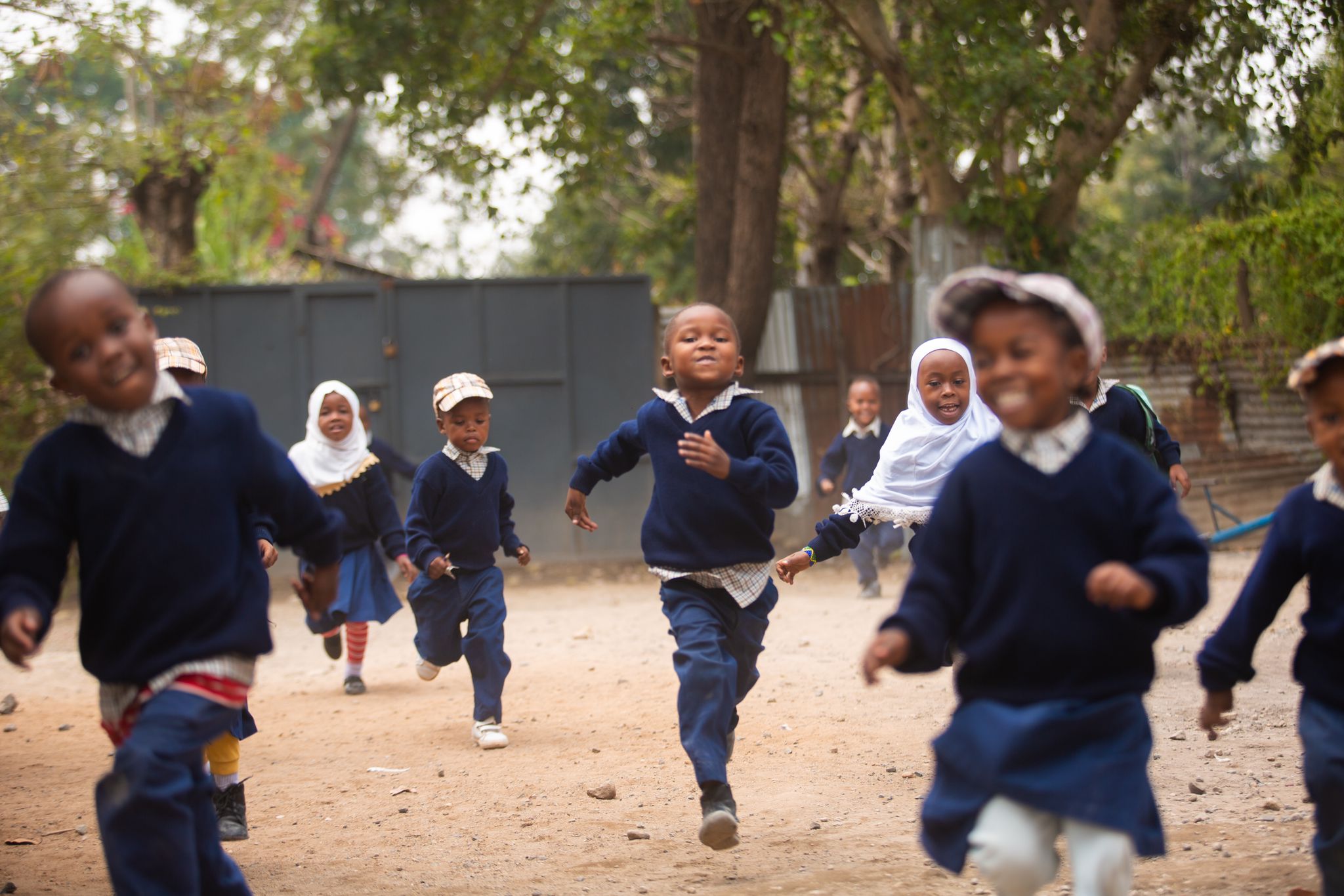 Children running and smiling at a school in Tanzania