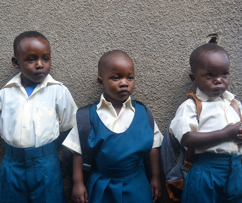 Tanzanian children standing in their new uniforms